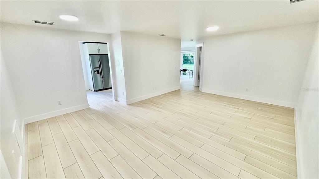 712 19th Street Orlando, FL 32805 - Photo 15 of 28 a view of an empty room with kitchen and a window