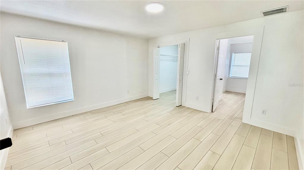 712 19th Street Orlando, FL 32805 - Photo 19 of 28 an empty room with wooden floor and windows