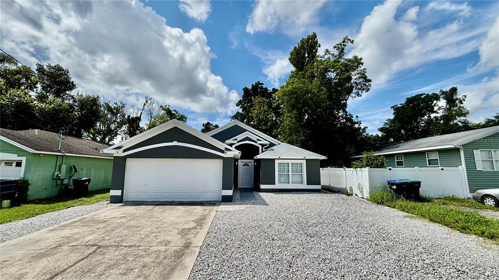 712 19th Street Orlando, FL 32805 - Photo 2 of 28 a front view of a house with a garden and trees