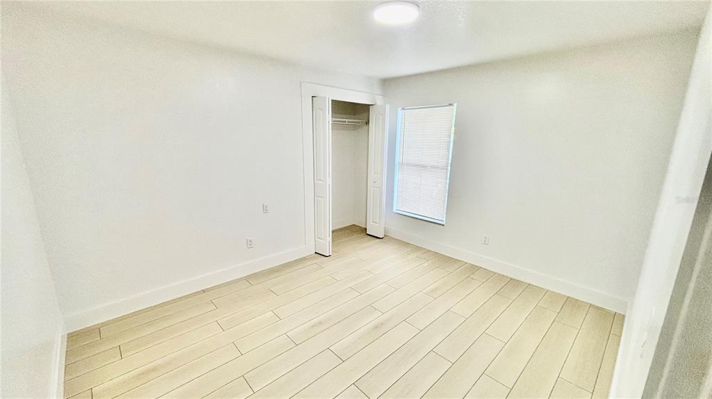 712 19th Street Orlando, FL 32805 - Photo 25 of 28 a view of a room with wooden floor and brick wall