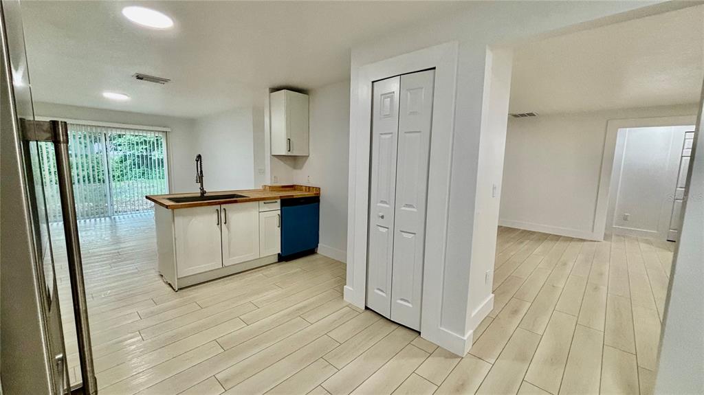 712 19th Street Orlando, FL 32805 - Photo 9 of 28 a view of a kitchen with wooden floor and electronic appliances