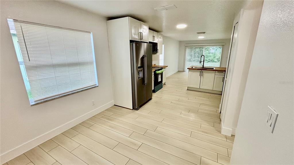 712 19th Street Orlando, FL 32805 - Photo 10 of 28 a view of a kitchen with a refrigerator and a sink