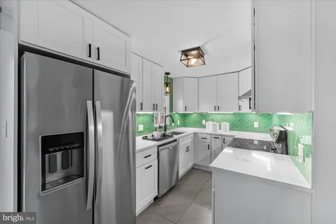 a kitchen with stainless steel appliances a refrigerator sink and stove