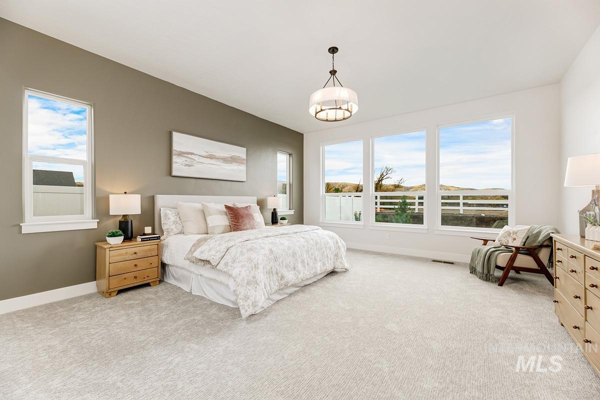 6774 Saddle Bred Way Star, ID 83669 - Photo 12 of 41 Bedroom featuring light carpet and multiple windows