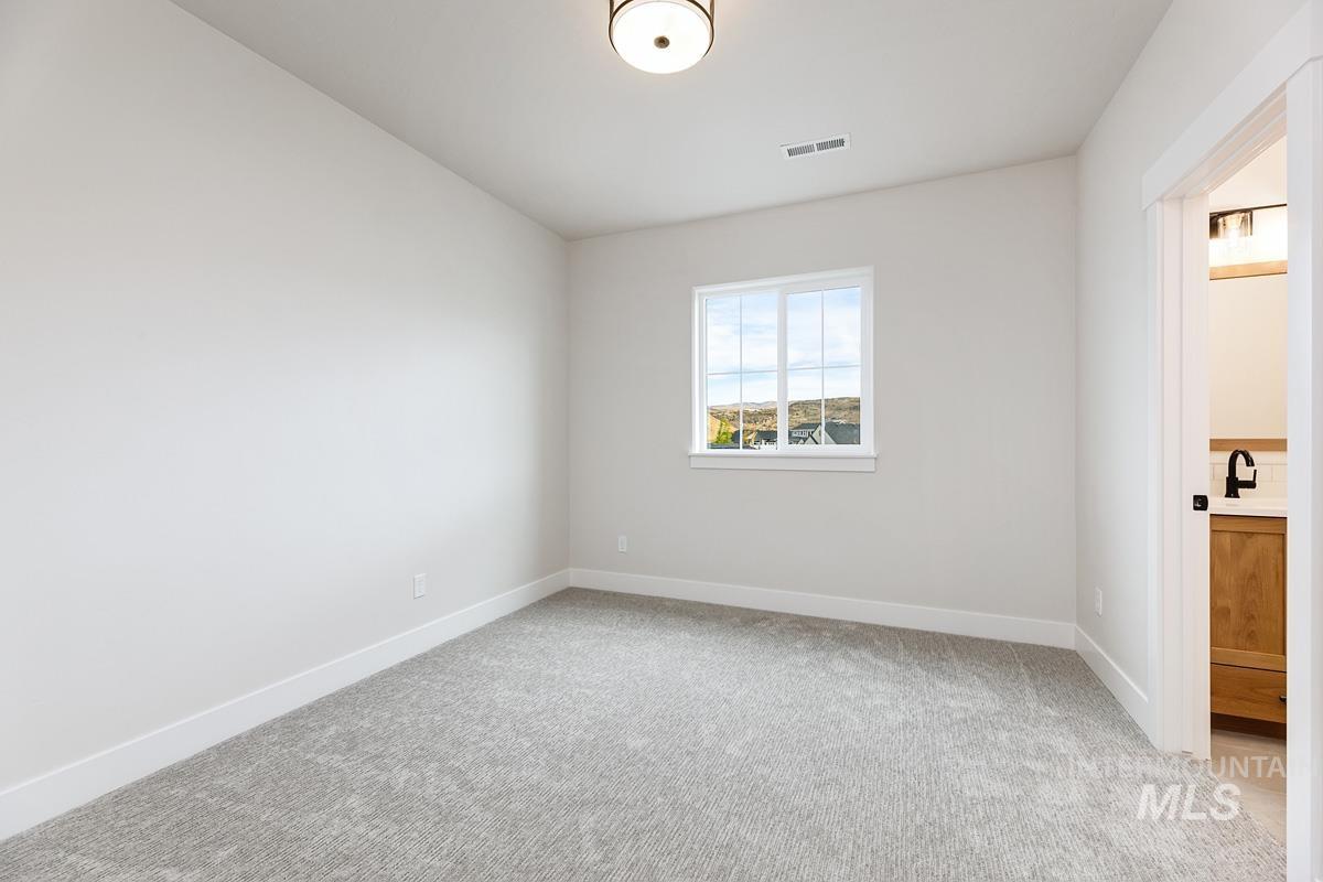 6774 Saddle Bred Way Star, ID 83669 - Photo 25 of 41 Unfurnished bedroom with light carpet and ensuite bath