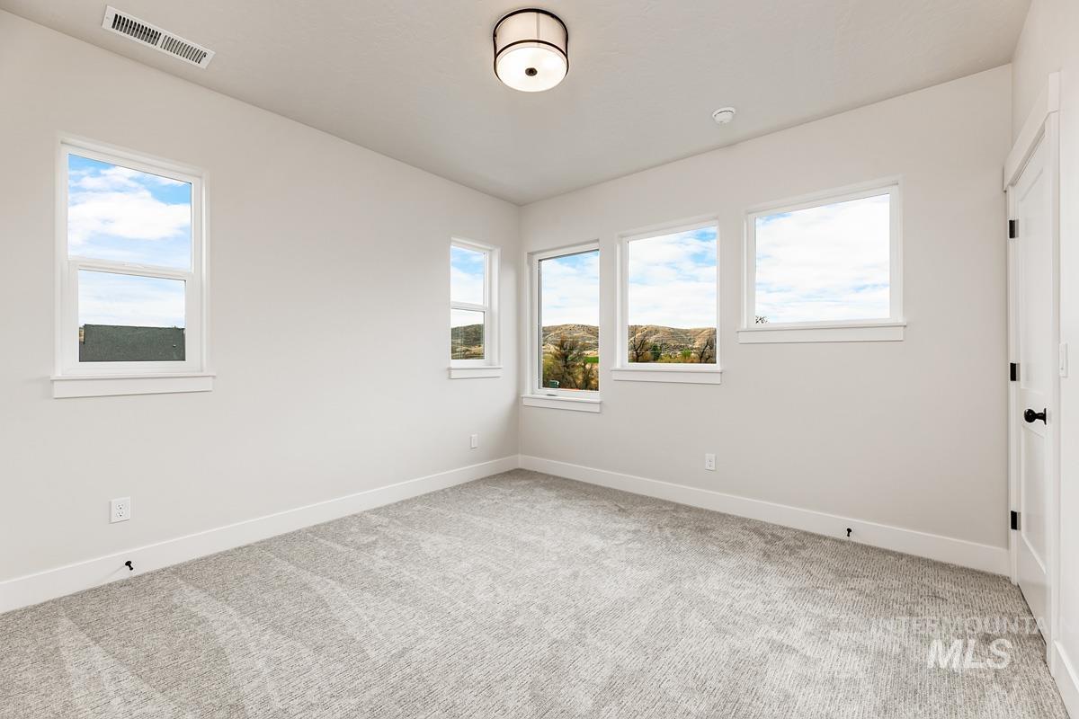 6774 Saddle Bred Way Star, ID 83669 - Photo 27 of 41 Unfurnished room with healthy amount of natural light and light carpet