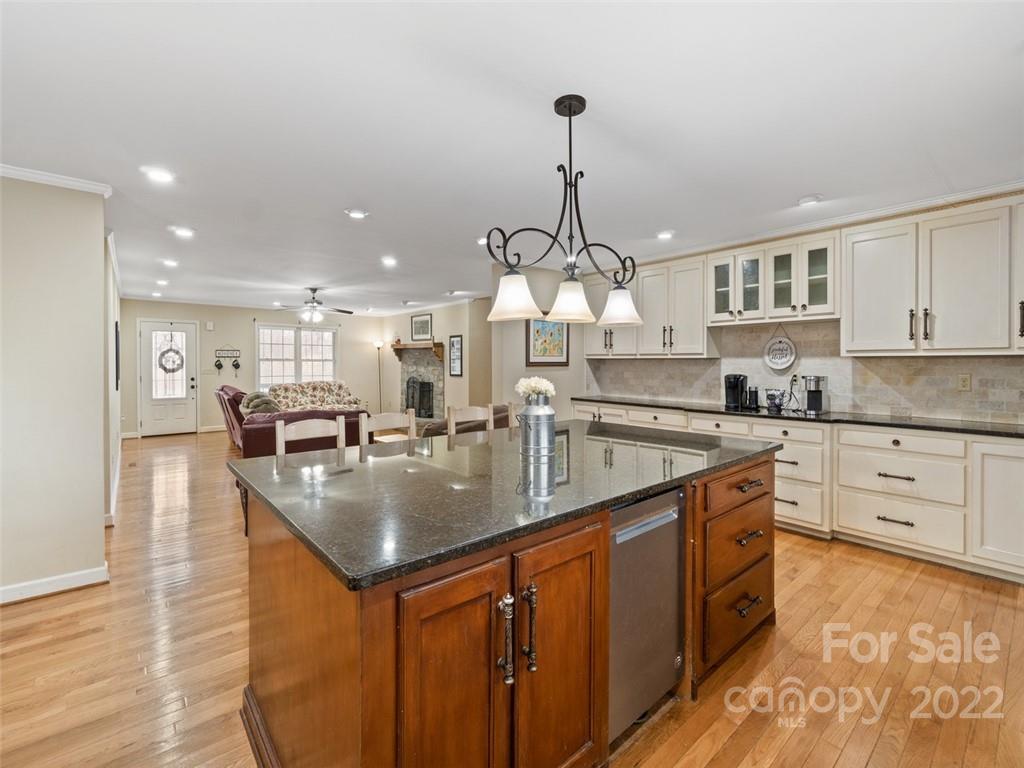 6758 Jenkins Road Morganton, NC 28655 - Photo 8 of 22 a kitchen with stainless steel appliances granite countertop a sink a stove and a wooden floors
