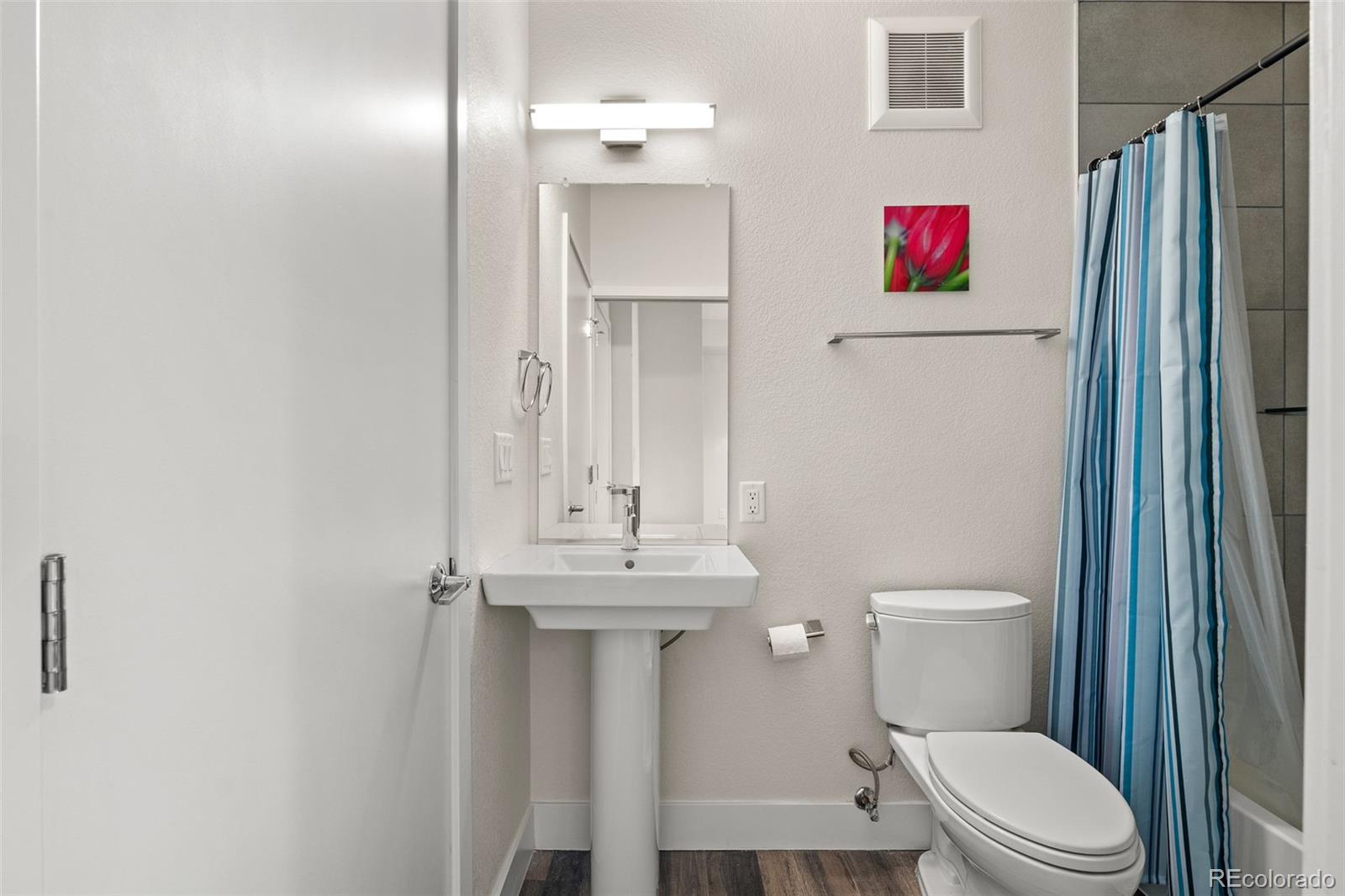 1204 South Reed Street Lakewood, CO 80232 - Photo 19 of 45 a white toilet sitting next to a bathroom sink