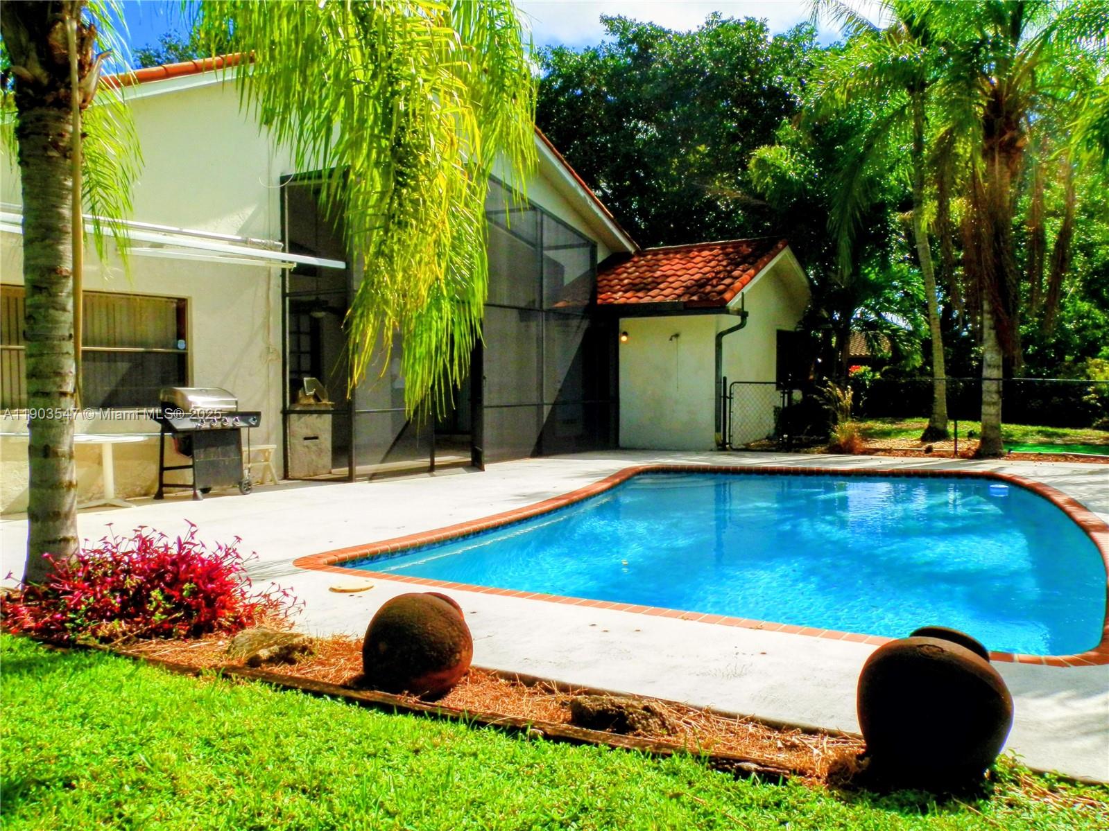 2700 Northwest 112th Avenue, Unit 2700 Coral Springs, FL 33065 - Photo 11 of 18 a view of a backyard with swimming pool and porch