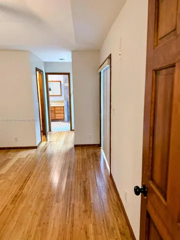 a view of a room with wooden floor and sliding window