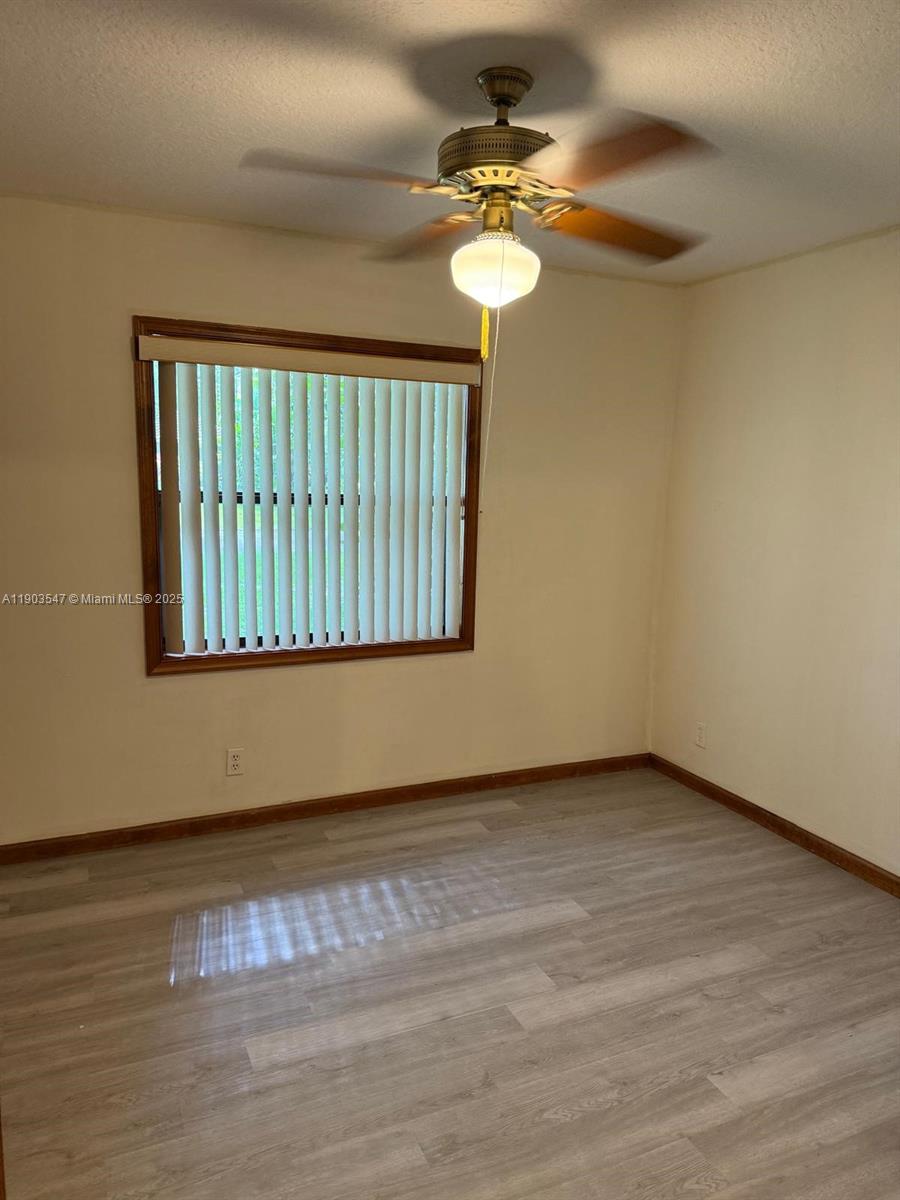 2700 Northwest 112th Avenue, Unit 2700 Coral Springs, FL 33065 - Photo 7 of 18 a view of an empty room with wooden floor
