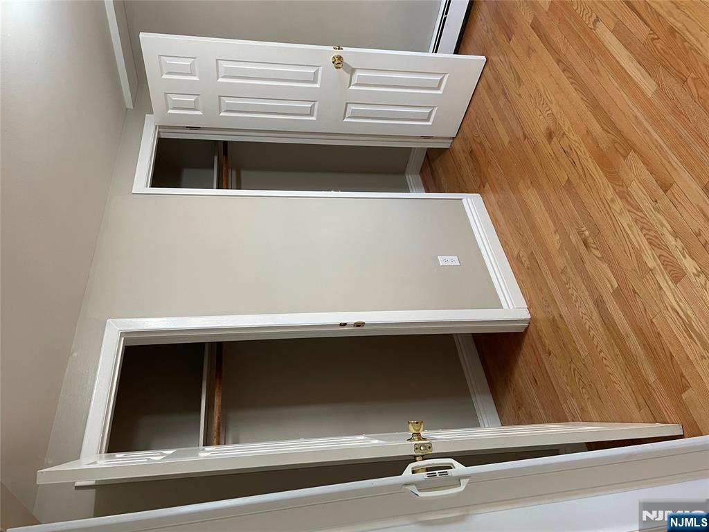 230 Anderson Avenue, Unit 1B Fairview, NJ 07022 - Photo 3 of 5 an empty room with wooden floor and closet