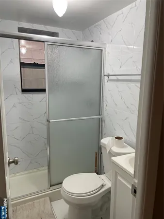a bathroom with a shower and a toilet