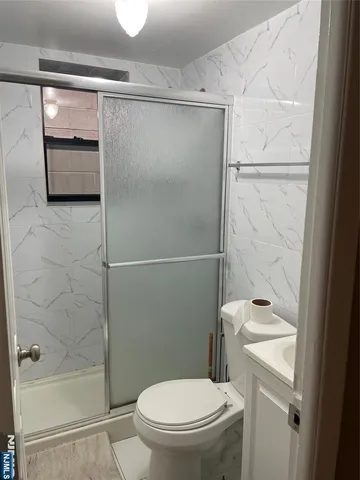 a bathroom with a shower and a toilet