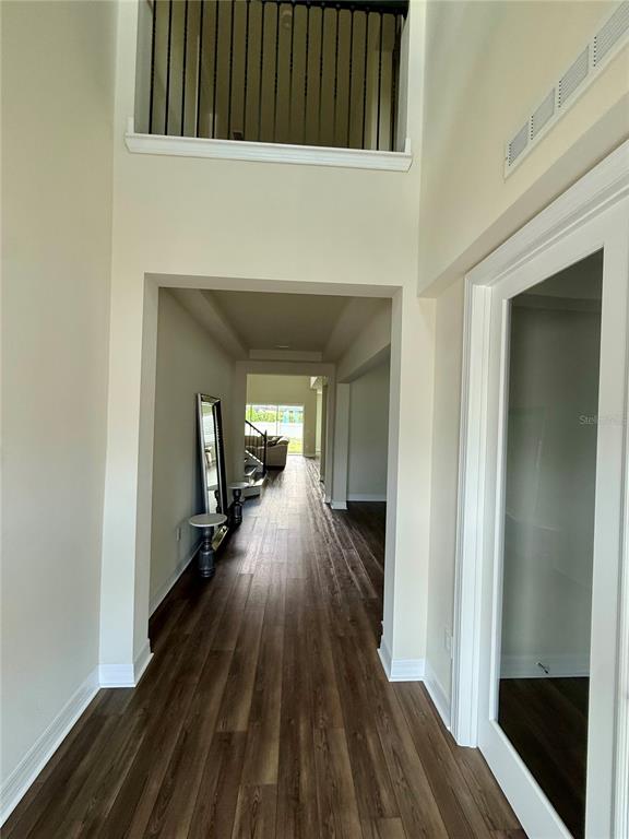 8441 Pk Clf Way Orlando, FL 32836 - Photo 7 of 59 a view of a hallway with wooden floor and staircase