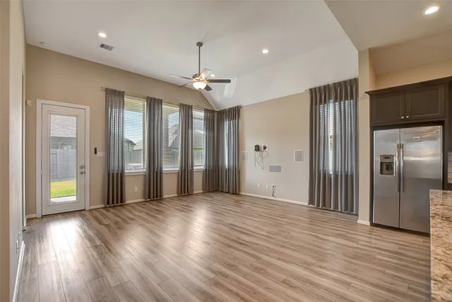 a view of a hallway with wooden floor
