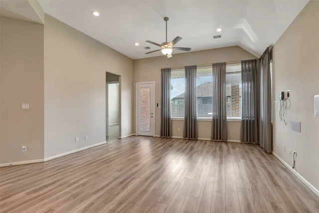 wooden floor in an empty room with a window