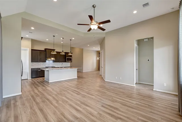 a view of kitchen with sink and refrigerator