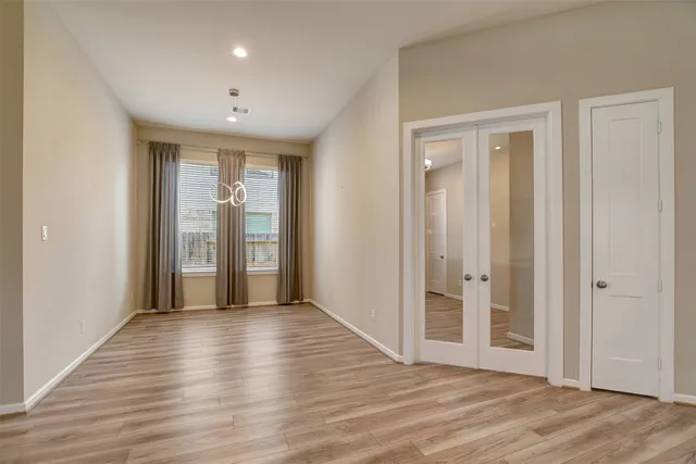 a view of a hallway with wooden floor