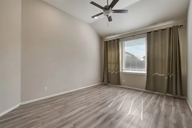 a view of a livingroom with a hardwood floor window and a ceiling fan