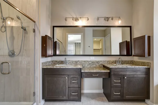 a bathroom with a granite countertop sink a vanity and a mirror