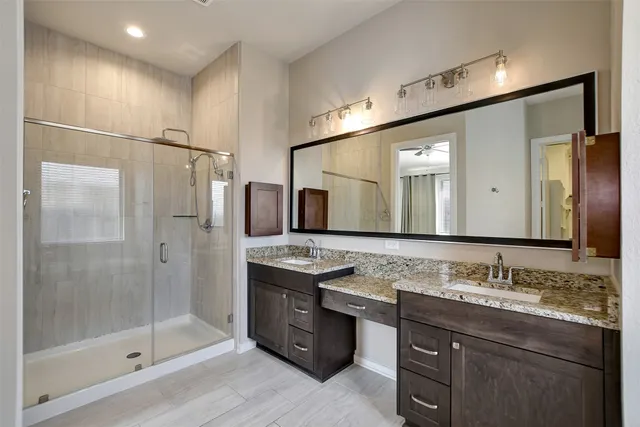 a bathroom with a granite countertop sink mirror and double