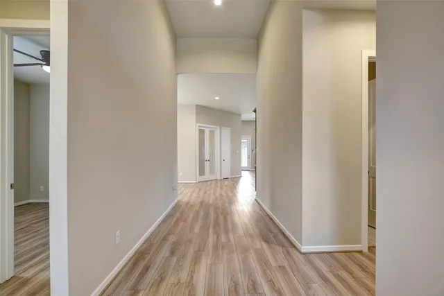 a view of a hallway with wooden floor