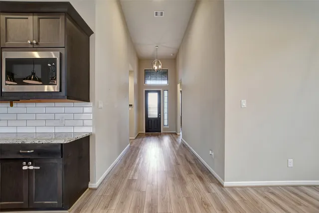 a view of hallway with wooden floor