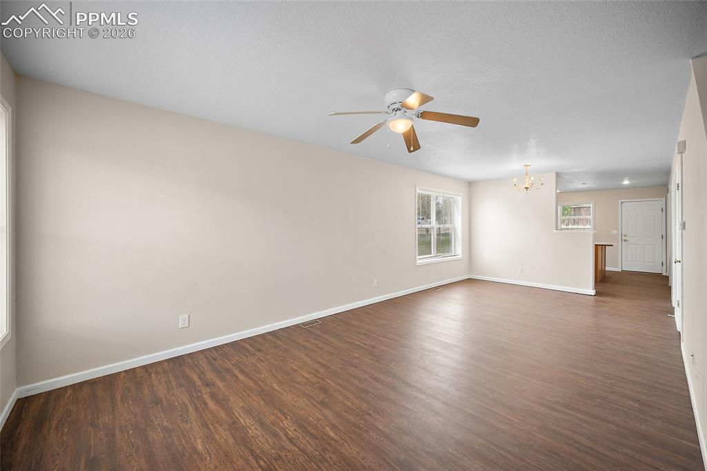 4400 Rawhide Road, Unit 157 Pueblo, CO 81008 - Photo 10 of 36 wooden floor in an empty room with a window