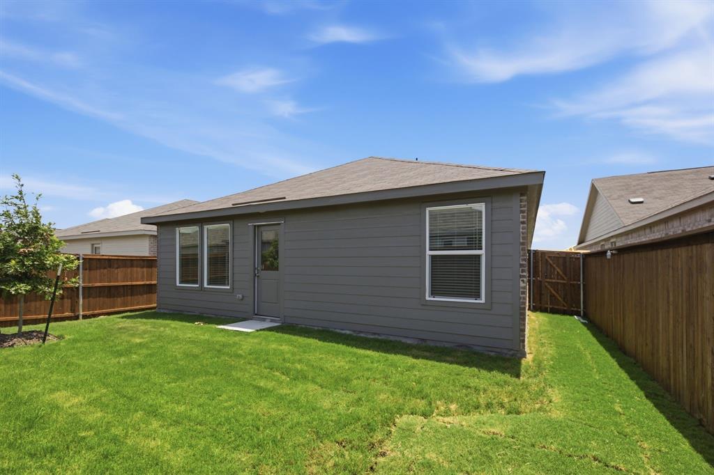 2128 Doc Holliday Road Joshua, TX 76058 - Photo 24 of 28 Lush green lawn with a newly planted tree