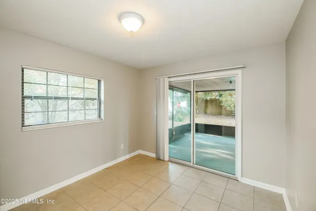 a view of an empty room with large windows