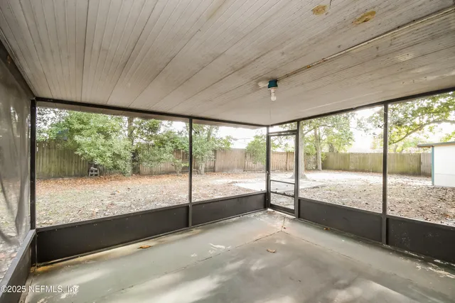 a view of a house with a tree in the background