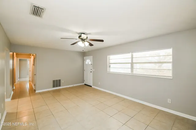 a view of an empty room with a window
