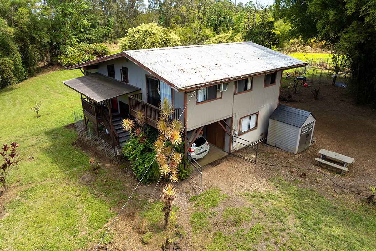 a roof deck with table and chairs under an umbrella
