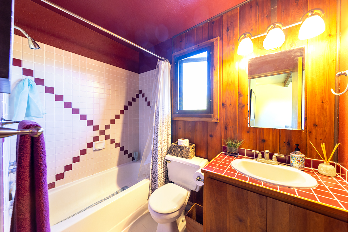 17-497 Homestead Road Kurtistown, HI 96760 - Photo 11 of 28 a bathroom with a granite countertop sink and a mirror