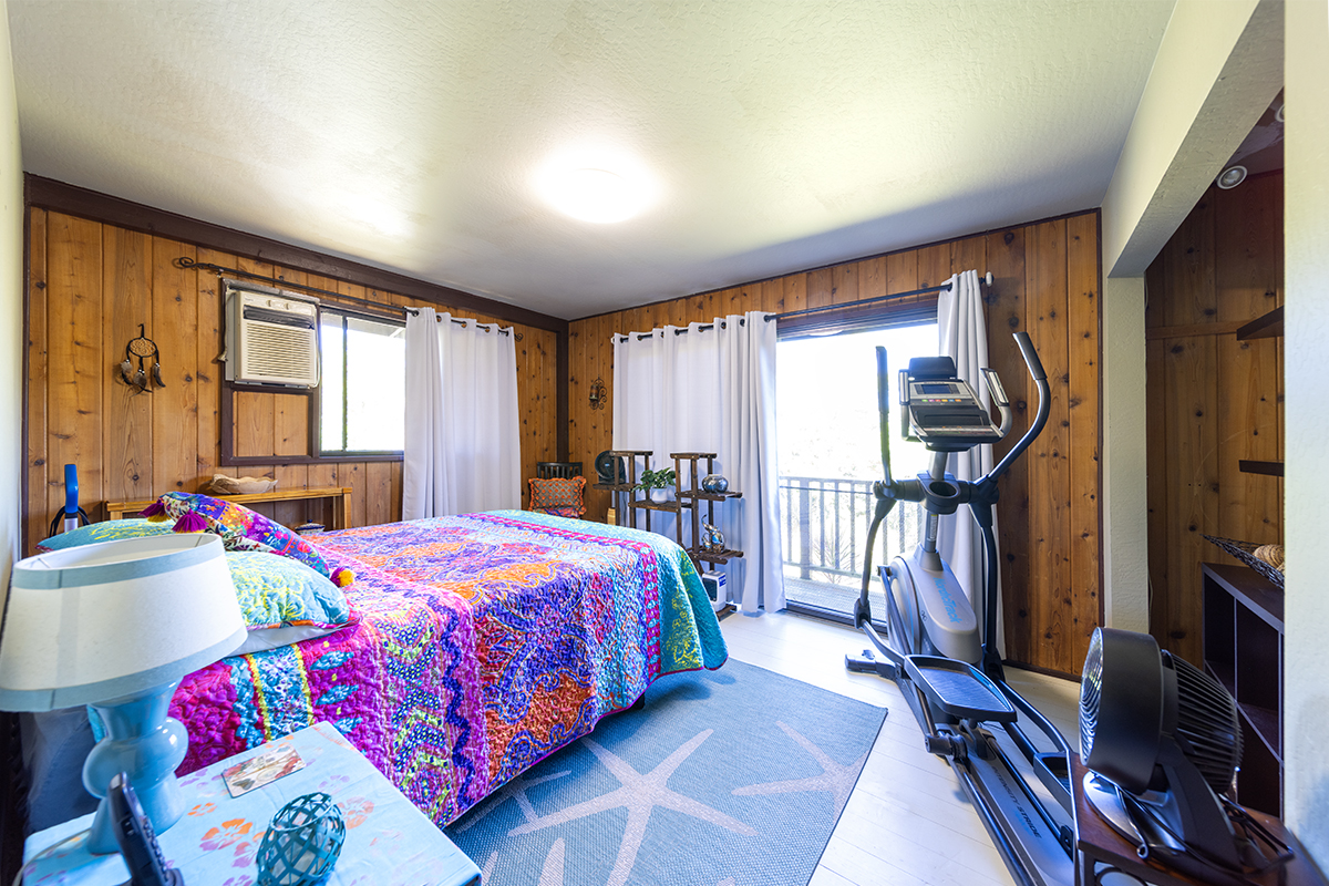 17-497 Homestead Road Kurtistown, HI 96760 - Photo 12 of 28 a bedroom with bed and a flat tv screen on dresser