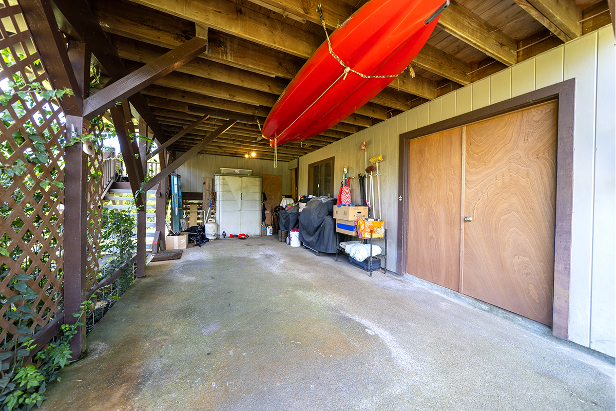17-497 Homestead Road Kurtistown, HI 96760 - Photo 17 of 28 a view of a porch with furniture and a garage