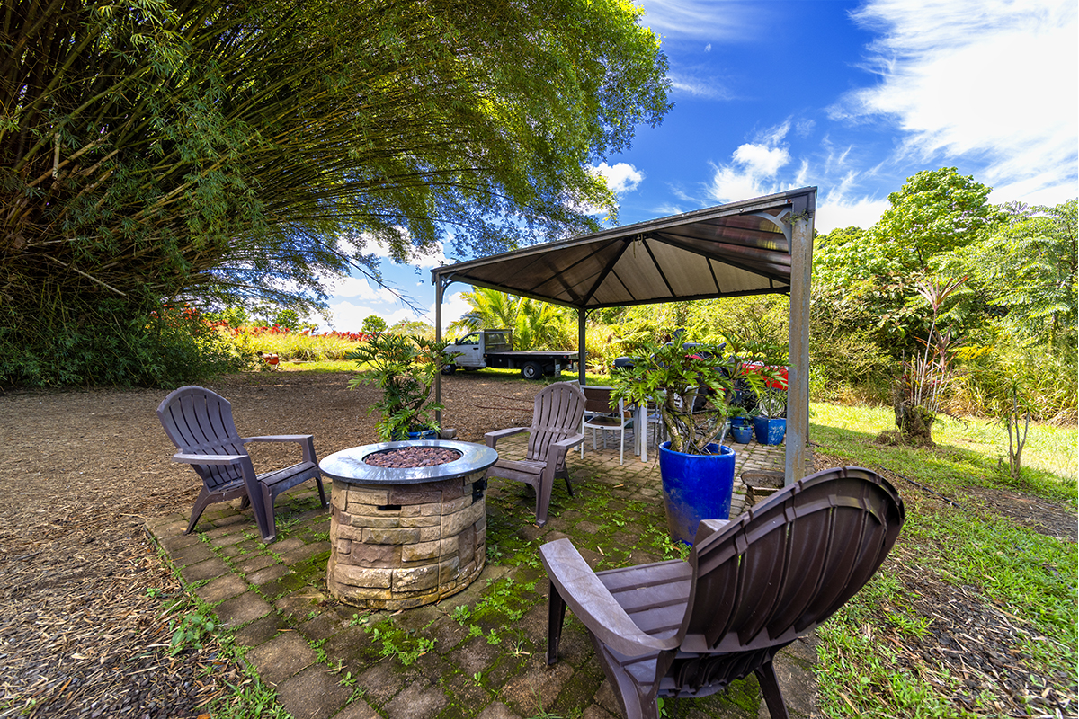 17-497 Homestead Road Kurtistown, HI 96760 - Photo 20 of 28 a patio with a yard table and chairs