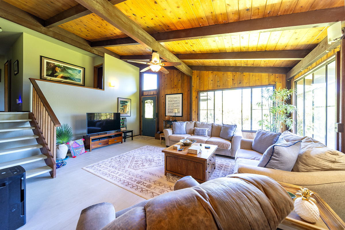 17-497 Homestead Road Kurtistown, HI 96760 - Photo 4 of 28 a living room with furniture a couch and a large window