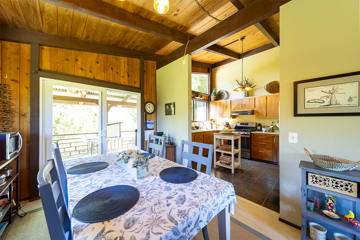17-497 Homestead Road Kurtistown, HI 96760 - Photo 7 of 28 a dining room with furniture and a floor to ceiling window
