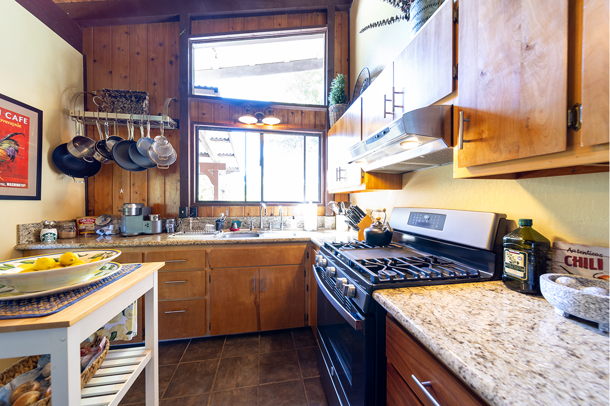 17-497 Homestead Road Kurtistown, HI 96760 - Photo 9 of 28 a kitchen with stainless steel appliances granite countertop a stove a sink and a microwave