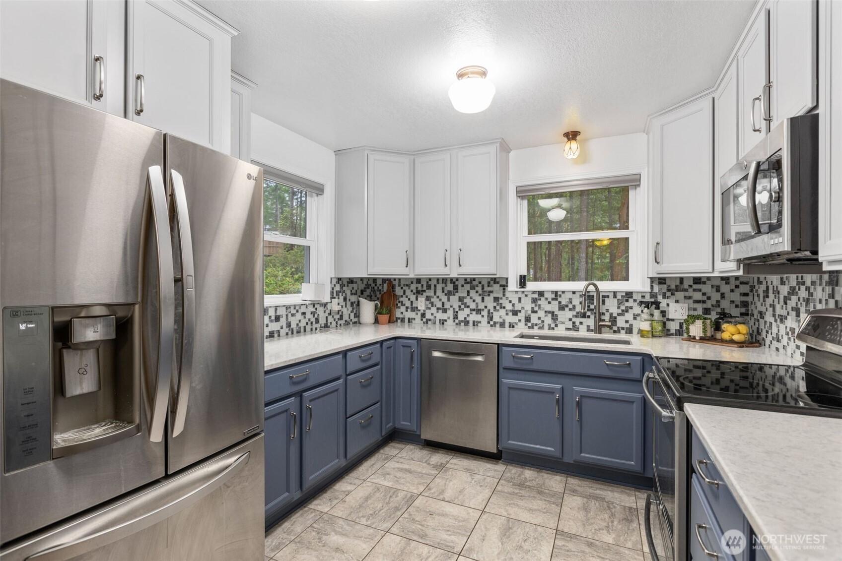 100 East Twanoh Heights Road South Belfair, WA 98528 - Photo 12 of 40 a kitchen with stainless steel appliances granite countertop a refrigerator and a stove