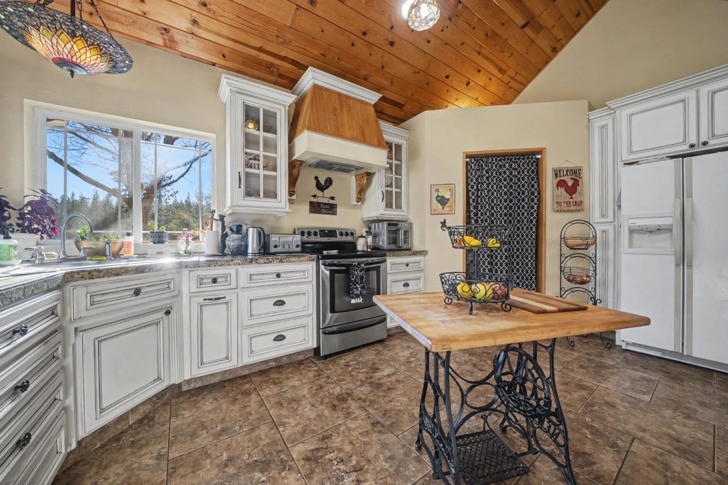 6145 Swiss Ranch Road Mountain Ranch, CA 95246 - Photo 16 of 84 a kitchen with white cabinets and refrigerator