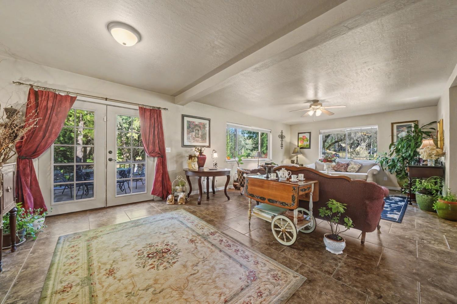 6145 Swiss Ranch Road Mountain Ranch, CA 95246 - Photo 23 of 84 a living room with furniture a window and potted plants