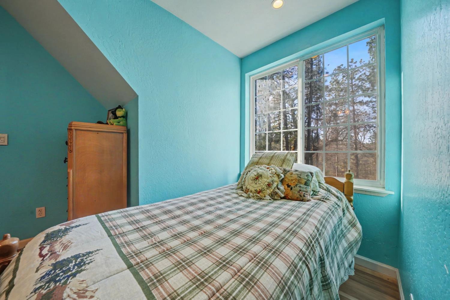 6145 Swiss Ranch Road Mountain Ranch, CA 95246 - Photo 43 of 84 a bedroom with a bed and wooden floor
