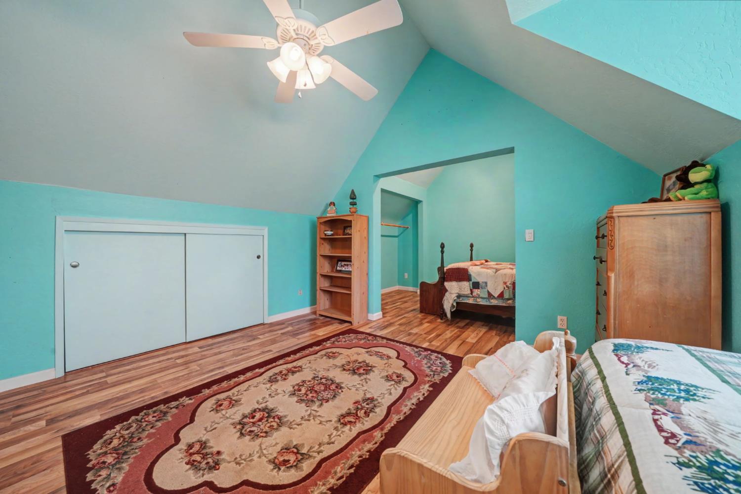 6145 Swiss Ranch Road Mountain Ranch, CA 95246 - Photo 44 of 84 a bedroom with a large bed and a chandelier