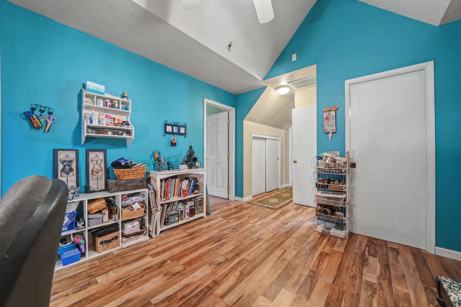 6145 Swiss Ranch Road Mountain Ranch, CA 95246 - Photo 50 of 84 a living room with a couch and a bookshelf with wooden floor