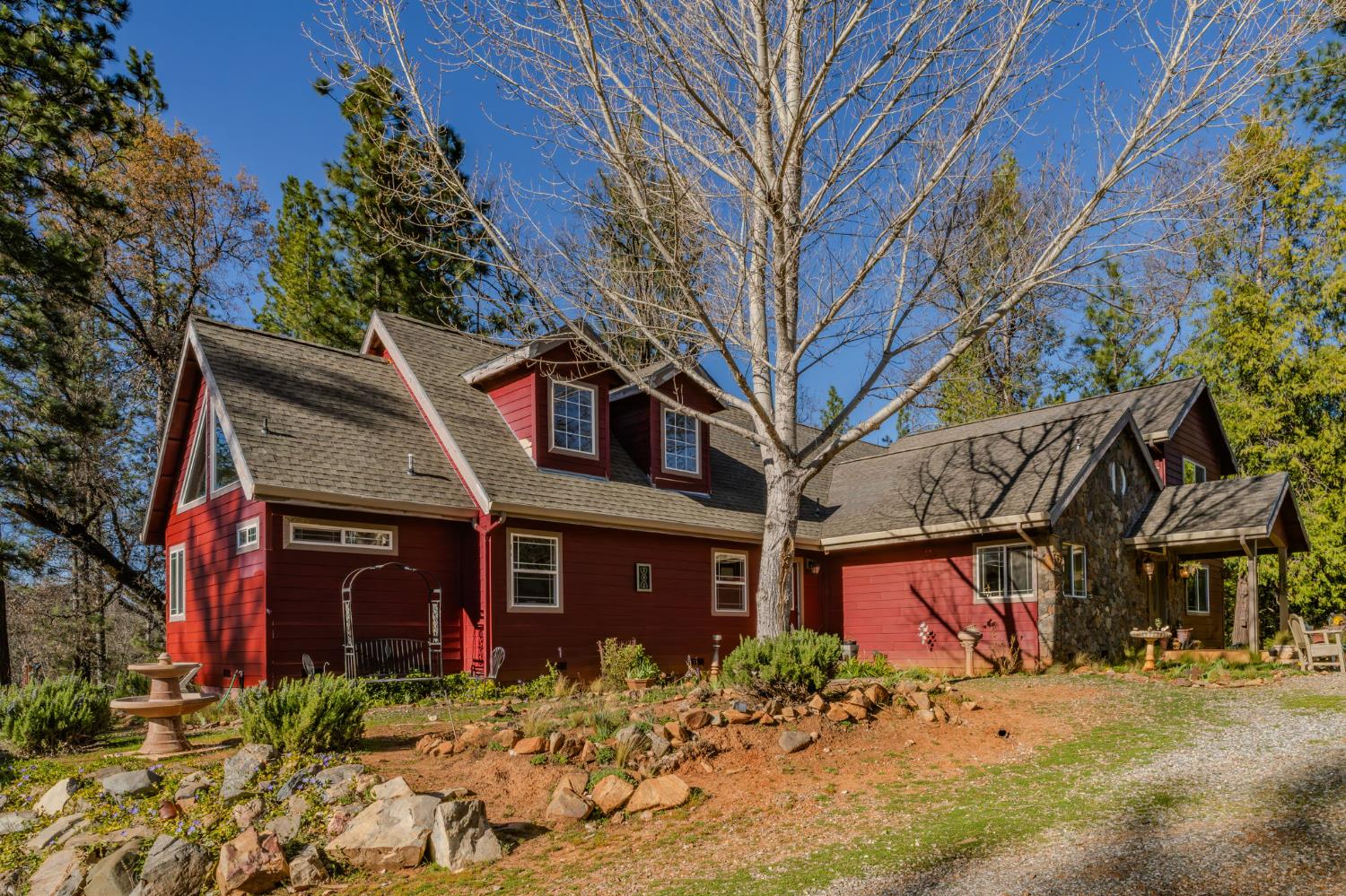 6145 Swiss Ranch Road Mountain Ranch, CA 95246 - Photo 5 of 84 a view of a house with a tree front of house