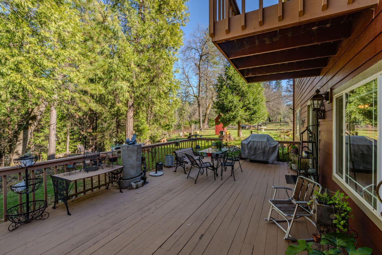 6145 Swiss Ranch Road Mountain Ranch, CA 95246 - Photo 64 of 84 a view of a patio with table and chairs potted plants with wooden floor and fence
