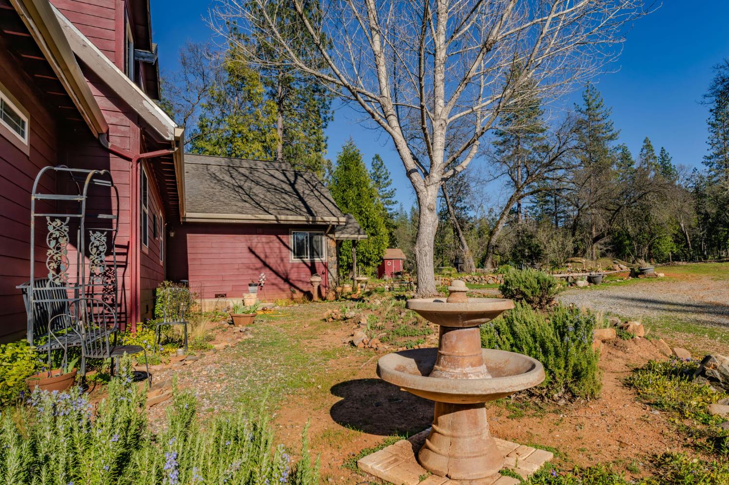 6145 Swiss Ranch Road Mountain Ranch, CA 95246 - Photo 65 of 84 a view of a fountain in the backyard of house
